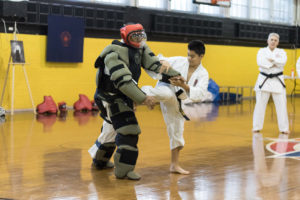 A young Black Belt student demonstrating technique in self-defence in the Sun Youth gymnasium.  