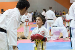 A black belt member instructing a fellow participant on sparring at the tournament.  