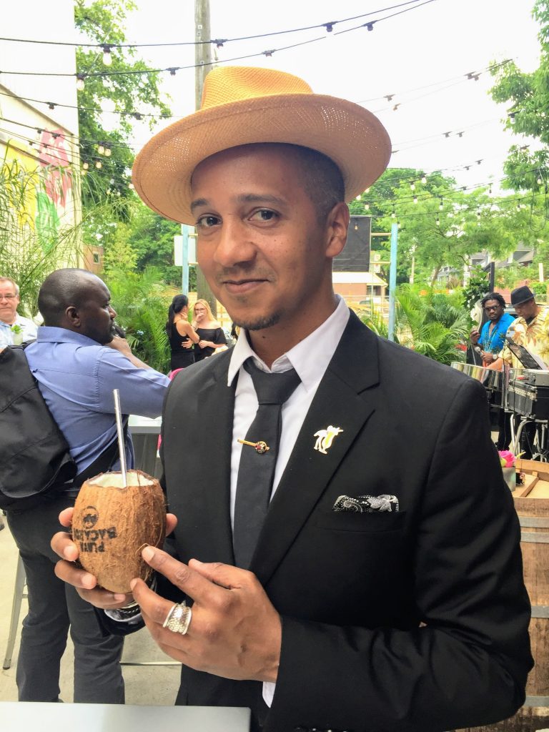 Juan holding coconut cocktail